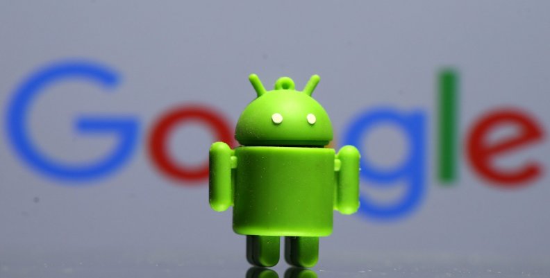 A 3D printed Android mascot Bugdroid is seen in front of a Google logo in this illustration