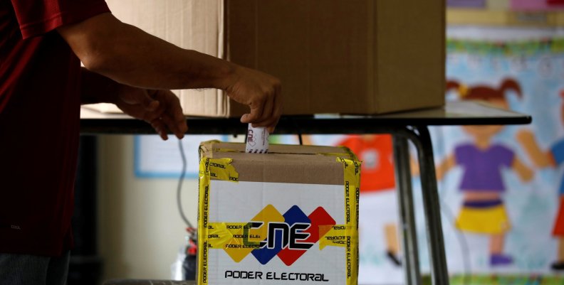 A man casts his vote in a polling station during a nationwide election for new governors in Caracas