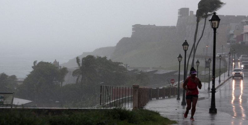 A woman runs in the rain as Hurricane Irma slammed across islands in the northern Caribbean on Wednesday, in San Juan