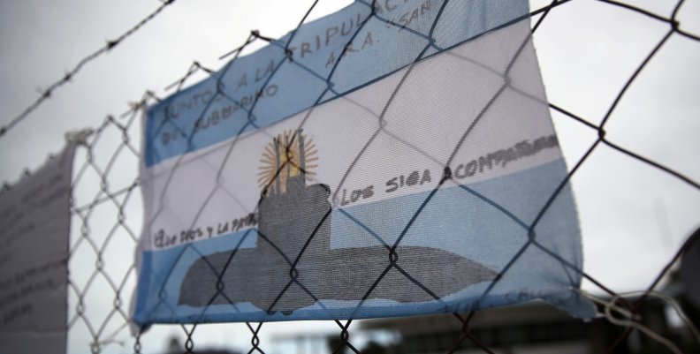 An Argentine national flag with messages in support of the 44 crew members of the ARA San Juan submarine missing at sea is seen placed on a fence at the Argentine Naval Base where it sailed from, in Mar del Plata