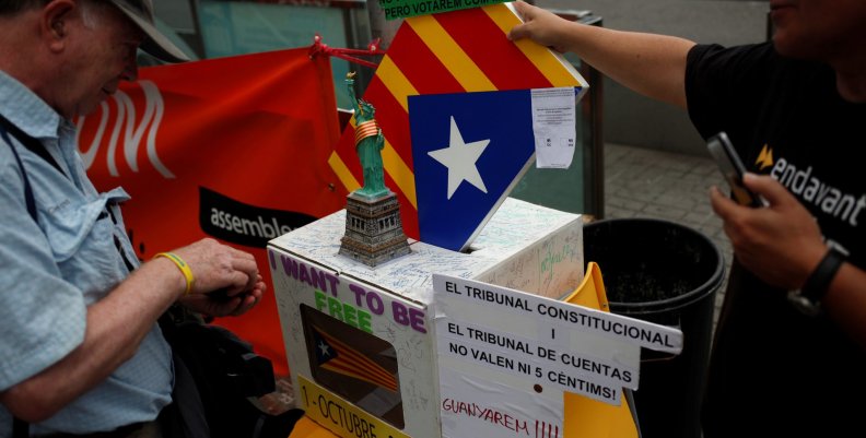 ANC member and public worker of the Terrasa's town hall, Pep Rovira, talks to a man during a protest in favor of the banned October 1 independence referendum in Barcelona