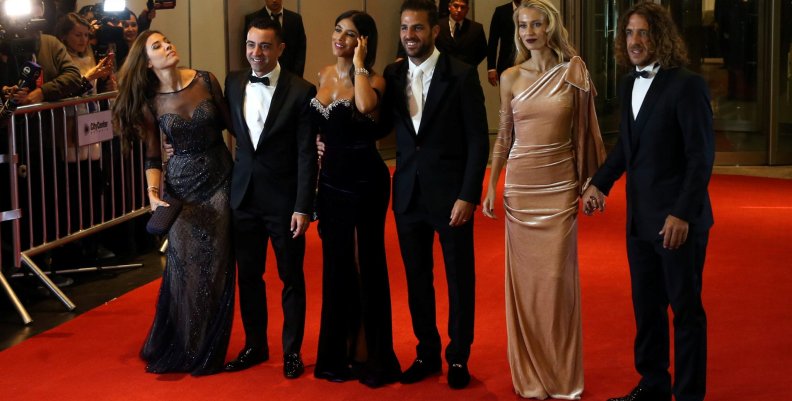 Argentine soccer player Lionel Messi's former Barcelona FC teammates and their wives pose for photographers as they arrive at the wedding of Messi and Antonela Roccuzzo in Rosario