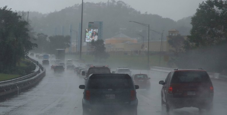 Cars drive on a highway during rain before the arrival of the Hurricane Maria in San Juan