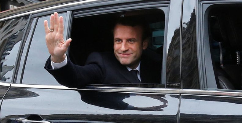 Emmanuel Macron, head of the political movement En Marche !, or Onwards !, and candidate for the 2017 presidential election, waves from his car as he leaves his home during the second round of the election, in Paris