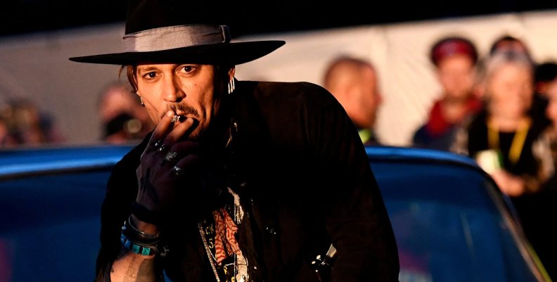 FILE PHOTO: Actor Johnny Depp poses on a Cadillac at Worthy Farm in Somerset during the Glastonbury Festival FILE PHOTO: Actor Johnny Depp poses on a Cadillac at Worthy Farm in Somerset during the Glastonbury Festival