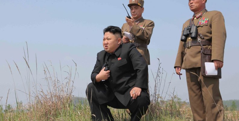 FILE PHOTO: North Korean leader Kim Jong Un guides the multiple-rocket launching drill of women's sub-units under KPA Unit 851