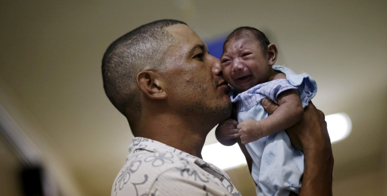 FILE PHOTO: Silva holds his son Gustavo Henrique, who has microcephaly, at the Oswaldo Cruz Hospital in Recife