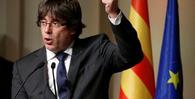 Former Catalan leader Carles Puigdemont gestures during a meeting with Catalan mayors in Brussels