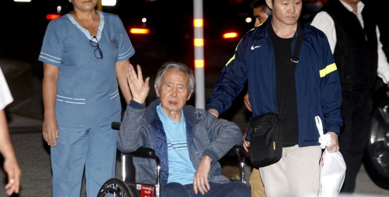 Former Peruvian President Alberto Fujimori accompanied by his son Kenji Fujimori leaves the Centenary hospital in Lima