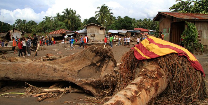 Logs swept by flashfloods lie in a village in Salvador, Lanao del Norte