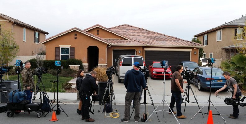 Members of the news media stand outside the home of the Turpins in Perris