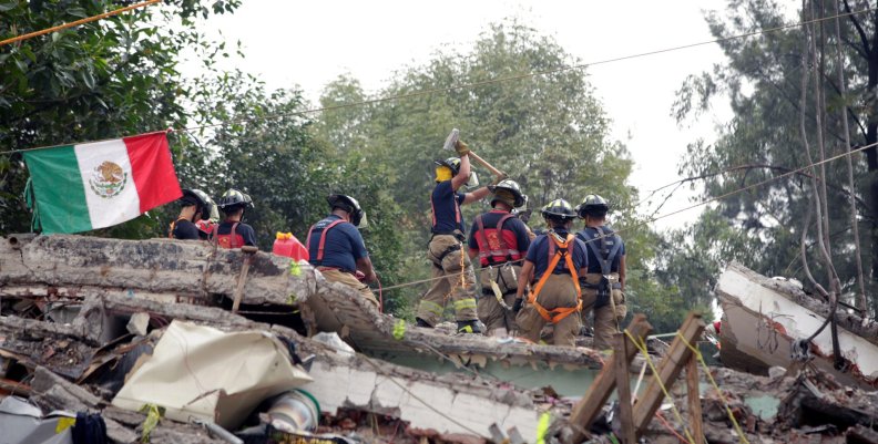 Mexican fire fighters work through the rubble of a collapsed multi family residential, after an earthquake, in Mexico City Mexican fire fighters work through the rubble of a collapsed multi family residential, after an earthquake, in Mexico City