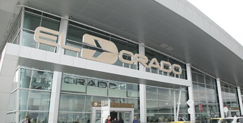 Imagen de la entrada del Aeropuerto El Dorado de Bogotá donde aparecen las letras y el logotipo en color dorado.