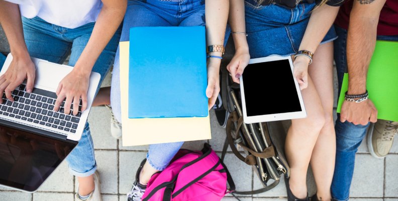 Jóvenes utilizando diferentes dispositivos electrónicos. Foto tomad de FreePik 