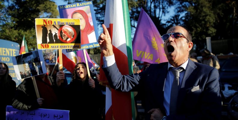 Opponents of Iranian President Hassan Rouhani hold a protest outside the Iranian embassy in Rome