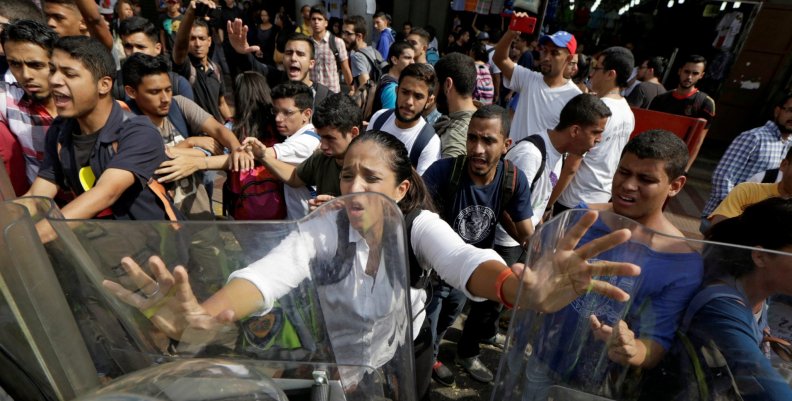 Opposition supporters clash with riot police in front of a courthouse in Caracas Opposition supporters clash with riot police in front of a courthouse in Caracas