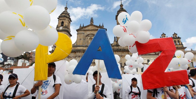 People form the word Peace with letters at the Bolivar square outside the cathedral in Bogota