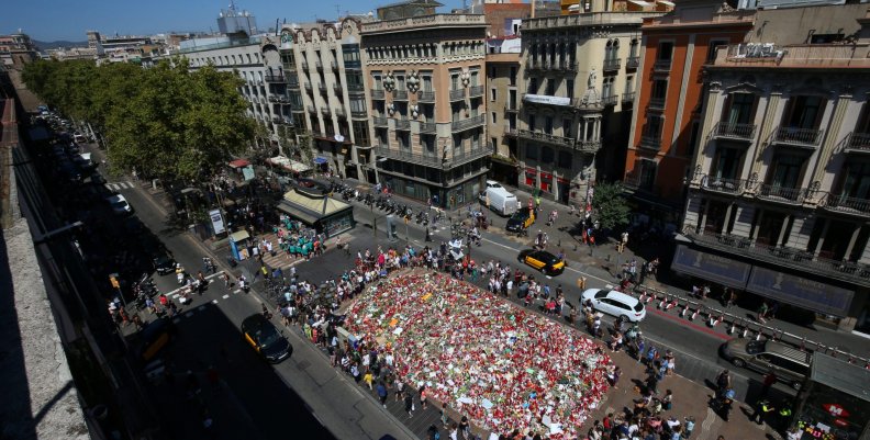 People gather at an impromptu memorial where a van crashed into pedestrians at Las Ramblas in Barcelona