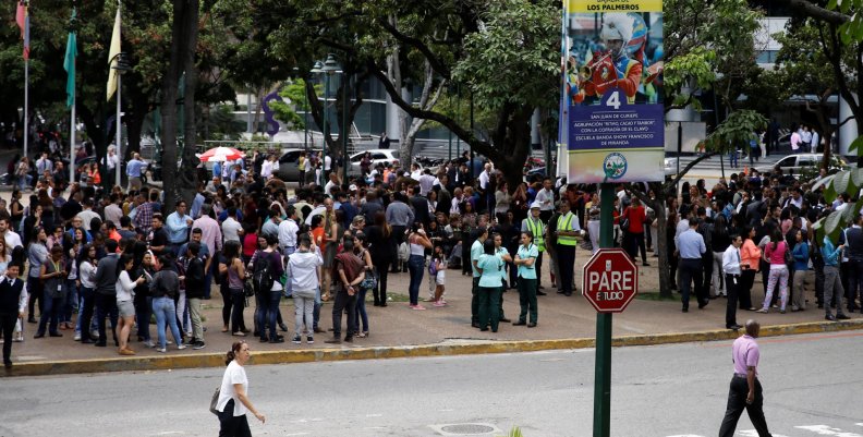 People gather in the street after an earthquake in Caracas