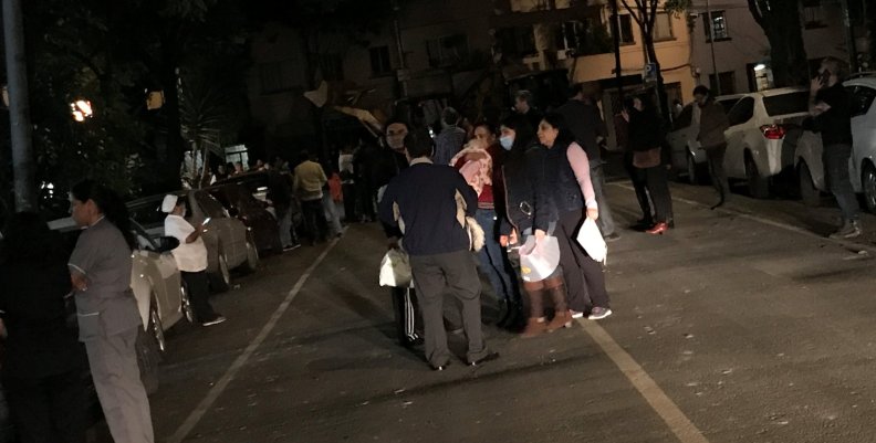 People gather on a street after an earthquake hit Mexico City