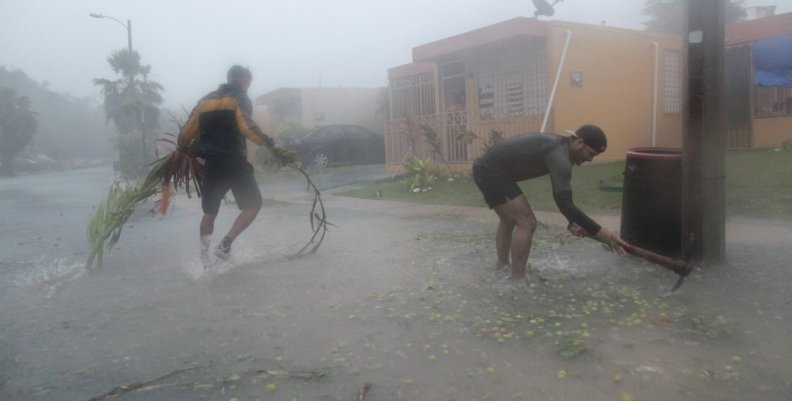 People pick up debris as Hurricane Irma howled past Puerto Rico after thrashing several smaller Caribbean islands, in Fajardo