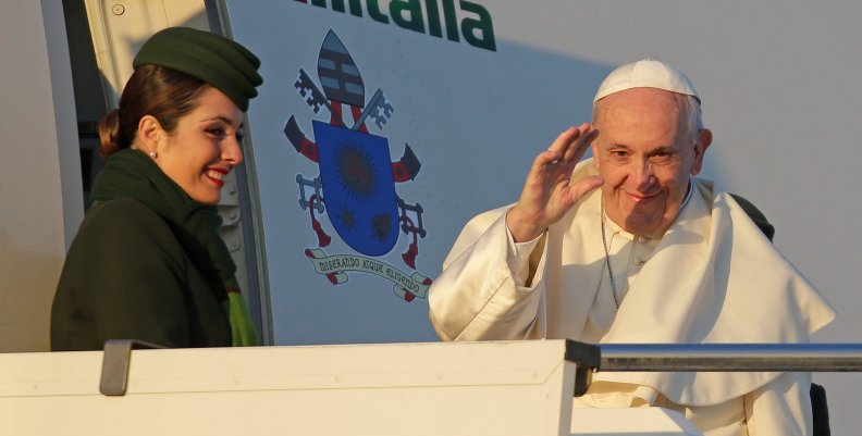 Pope Francis waves as he boards for his trip to Chile and Peru at Fiumicino International Airport in Rome