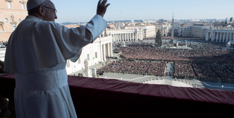 Pope Francis waves as he leads the "Urbi et Orbi" (to the city and the world) message from the balcony overlooking St. Peter's Square at the Vatican