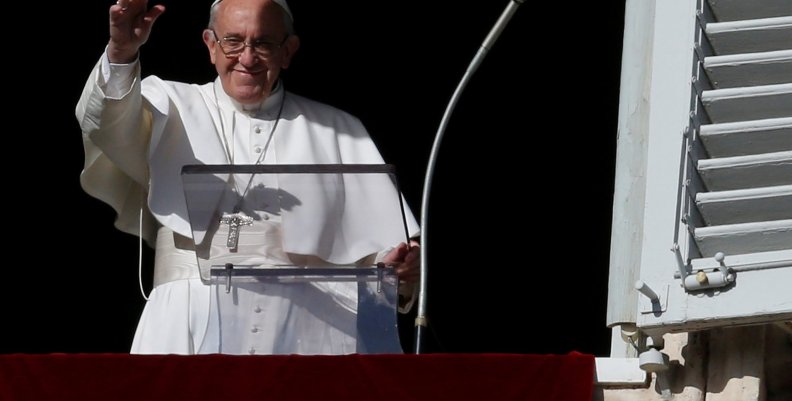 Pope Francis waves during his Sunday Angelus prayer, on the day of his birthday, in Saint Peter's square at the Vatican