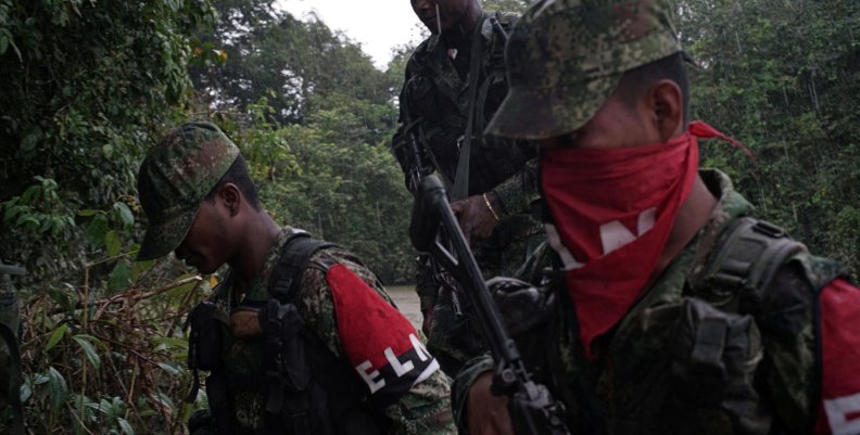 Rebels of Colombia's Marxist National Liberation Army get off a boat after patrolling the river, in the northwestern jungles