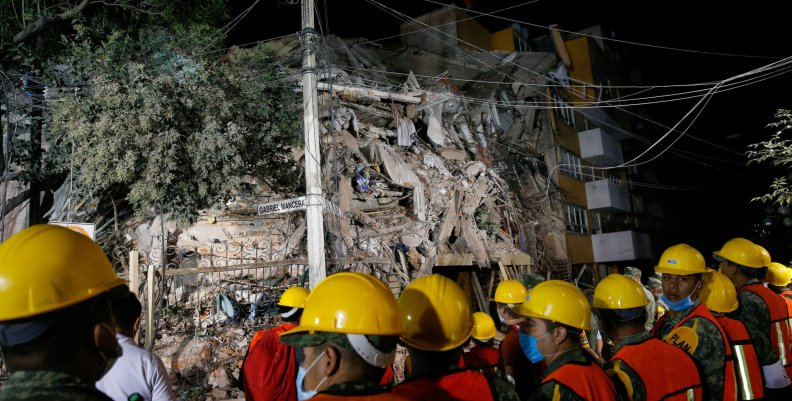 Rescuers work at the site of a collapsed building after an earthquake in Mexico City Rescuers work at the site of a collapsed building after an earthquake in Mexico City