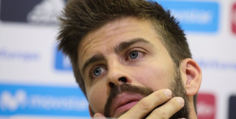 Spain's national soccer team player Gerard Pique gestures during a news conference at the training grounds in Las Rozas, outside Madrid