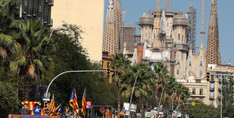 Tractors drive near the Sagrada Familia cathedral during a protest in favour of the banned referendum on independence from Spain in Barcelona