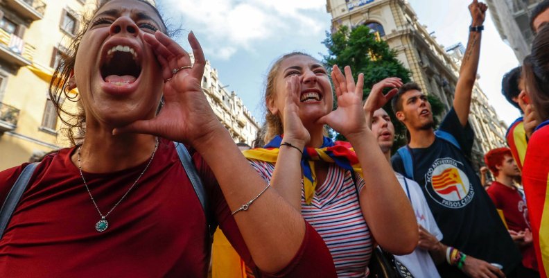 Women shout slogans against Spanish National Police during a gathering outside a National Police station, in Barcelona