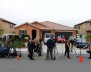 Members of the news media stand outside the home of the Turpins in Perris