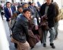 People carry a mourning man at a hospital after a suicide attack in Kabul