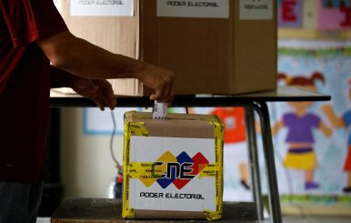 A man casts his vote in a polling station during a nationwide election for new governors in Caracas