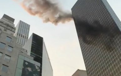 A smoke is seen rising from the roof of Trump Tower, in New York