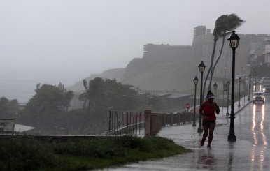 A woman runs in the rain as Hurricane Irma slammed across islands in the northern Caribbean on Wednesday, in San Juan