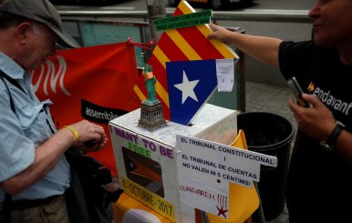 ANC member and public worker of the Terrasa's town hall, Pep Rovira, talks to a man during a protest in favor of the banned October 1 independence referendum in Barcelona