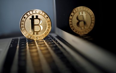 FILE PHOTO: A Bitcoin (virtual currency) coin is seen in an illustration picture taken at La Maison du Bitcoin in Paris