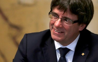 FILE PHOTO - Catalan President Puigdemont smiles as he chairs meeting in Barcelona