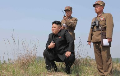 FILE PHOTO: North Korean leader Kim Jong Un guides the multiple-rocket launching drill of women's sub-units under KPA Unit 851