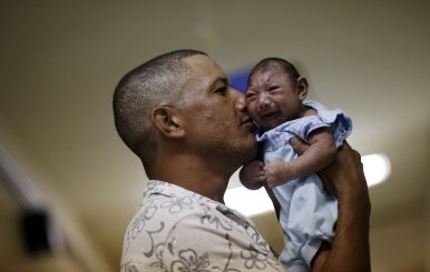 FILE PHOTO: Silva holds his son Gustavo Henrique, who has microcephaly, at the Oswaldo Cruz Hospital in Recife