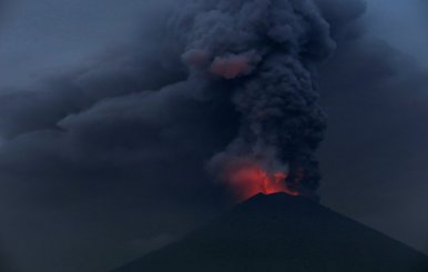 Glowing light of hot lava is seen during the eruption of Mount Agung as seen from Amed in Karangasem