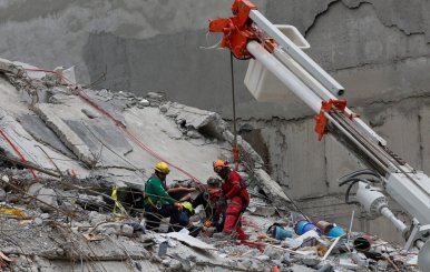 Members of Israeli and Mexican rescue teams search for survivors in the rubble of a collapsed building in Roma neighbourhood after an earthquake in Mexico City
