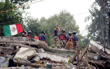 Mexican fire fighters work through the rubble of a collapsed multi family residential, after an earthquake, in Mexico City