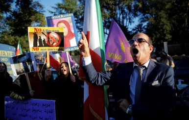 Opponents of Iranian President Hassan Rouhani hold a protest outside the Iranian embassy in Rome