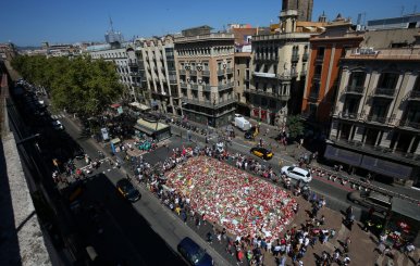 People gather at an impromptu memorial where a van crashed into pedestrians at Las Ramblas in Barcelona