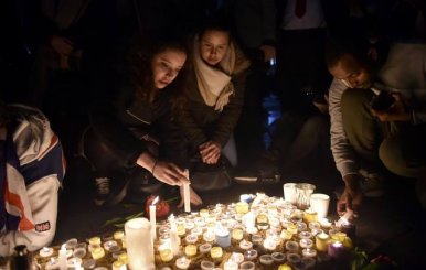 People light candles at a vigil in Trafalgar Square the day after an attack, in London