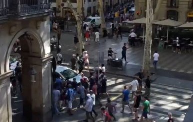 People move from the scene after a van crashed into pedestrians near the Las Ramblas avenue in central Barcelona